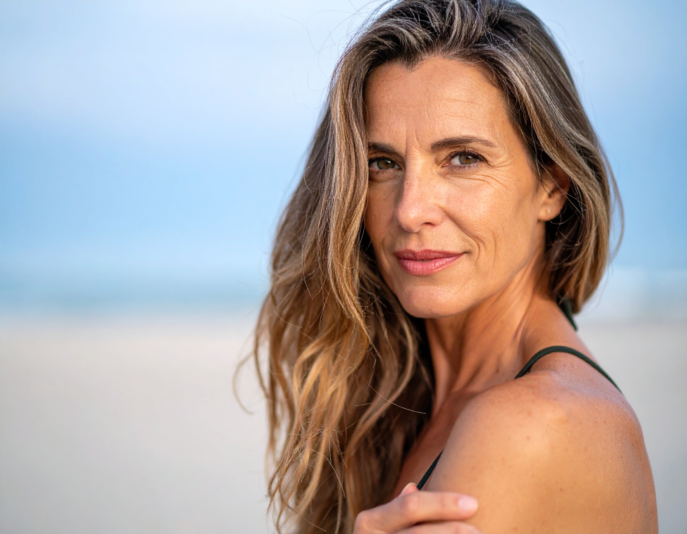 Woman experiencing menopause symptoms and gut health connection